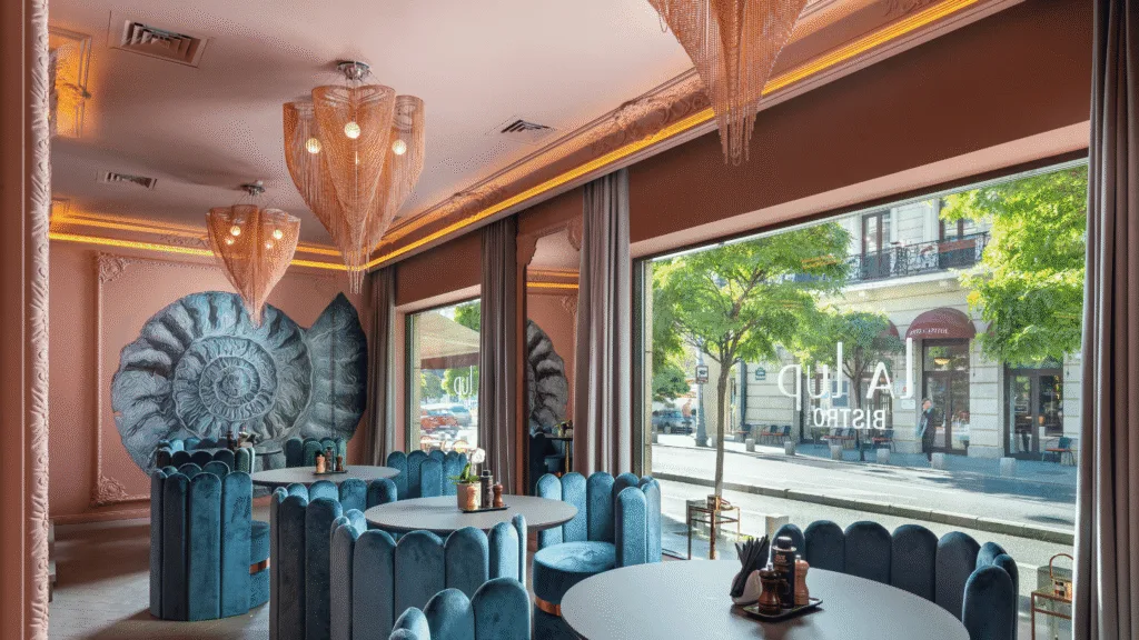 Decorative lighting in La Lup Bistro featuring willowlamp Big Love Clover chandeliers above velvet seating in Basel.